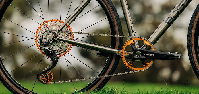 Drivetrain detail on a custom Bossi Grit SX, showing the Shimano GRX and orange Garbaruk components
